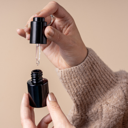 Protective Miron Dropper Bottle, Premium Packaging for Skincare & Oils Hand holding a dropper bottle with dark Miron glass packaging, preserving the potency and freshness of skincare or essential oils.